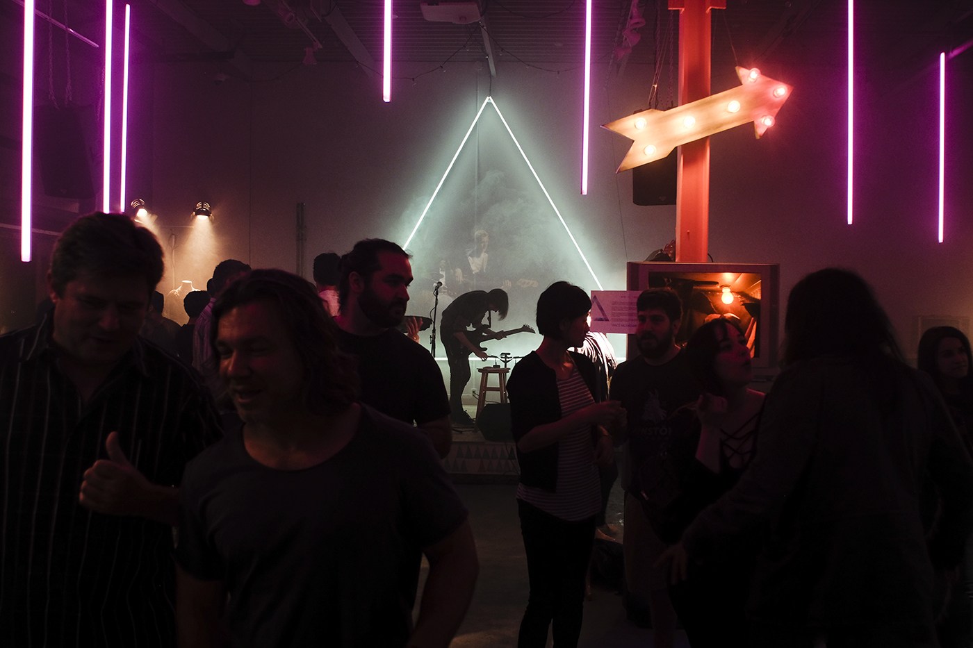 Guests gathered around the illuminated performance space