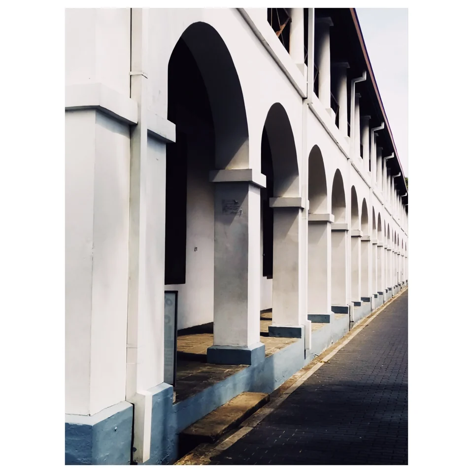 A white arcade with repeated archways