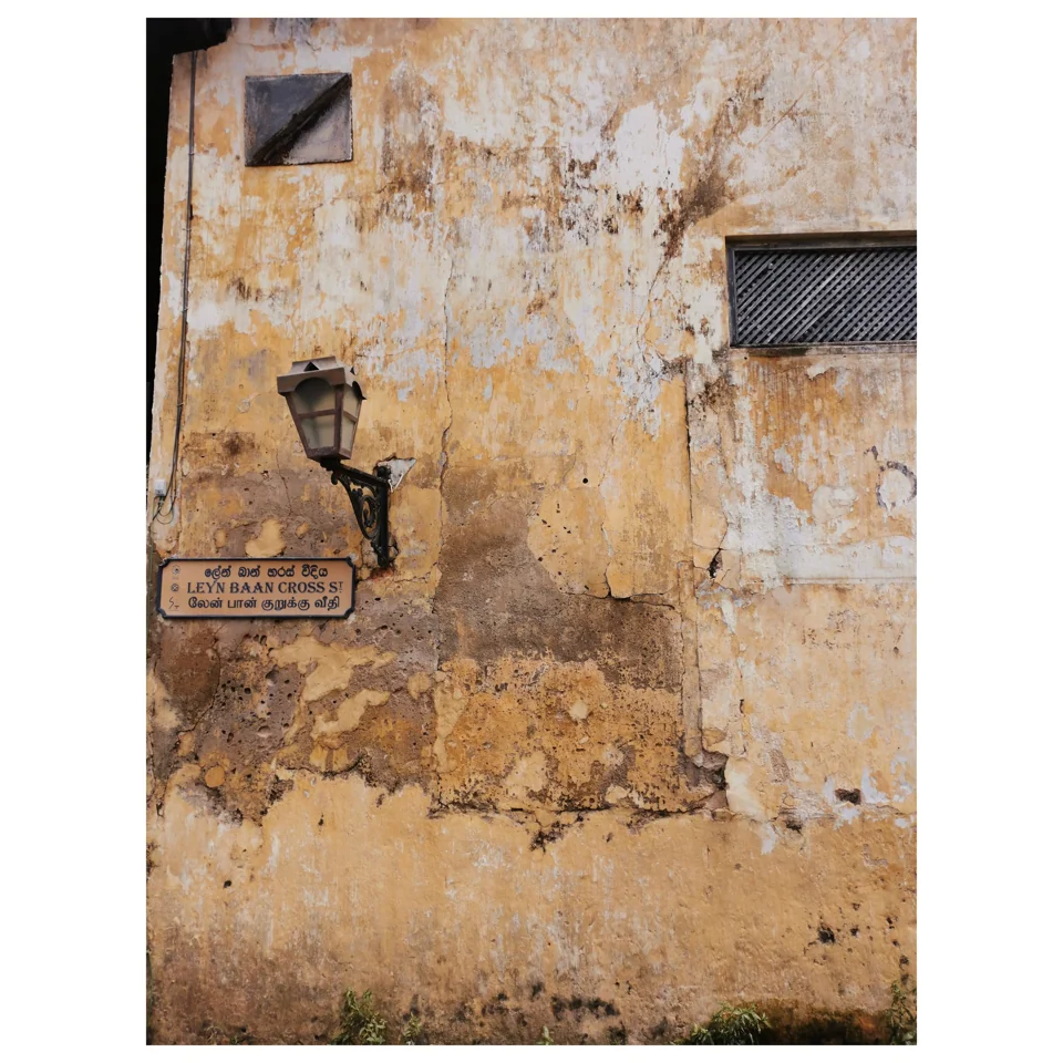 An outdoor tap on a weathered ochre wall