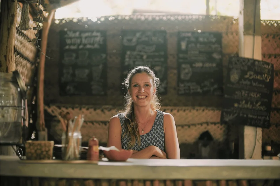 A woman behind the counter of a café