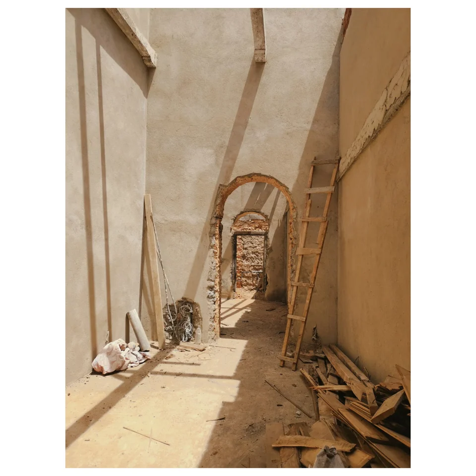 Sunlight falling through a long arched corridor