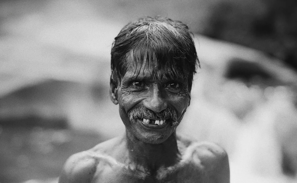 Black-and-white portrait of a smiling man