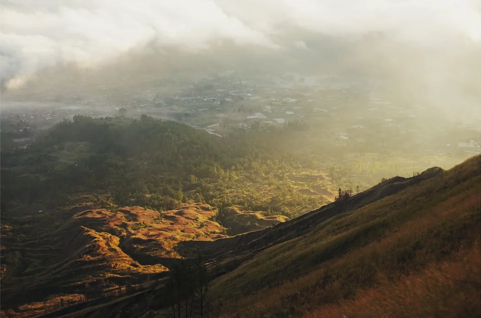 Sunlight breaking through cloud over a valley