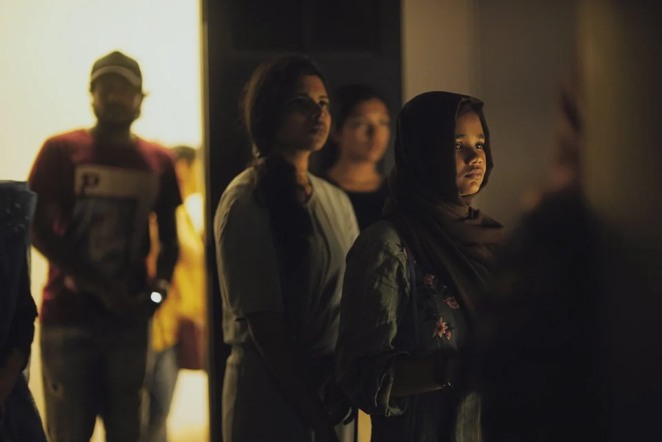People gathered in a dimly lit room
