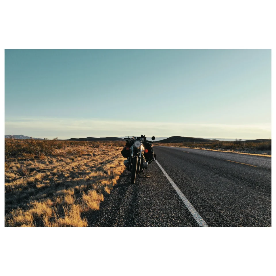 Riders on a road through open countryside