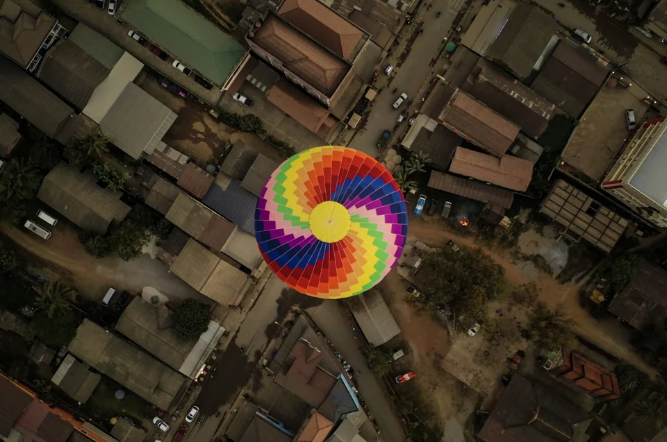 A colourful balloon above tightly packed city streets