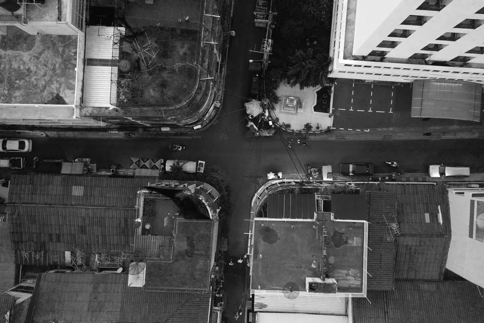 An urban intersection photographed from above in black and white