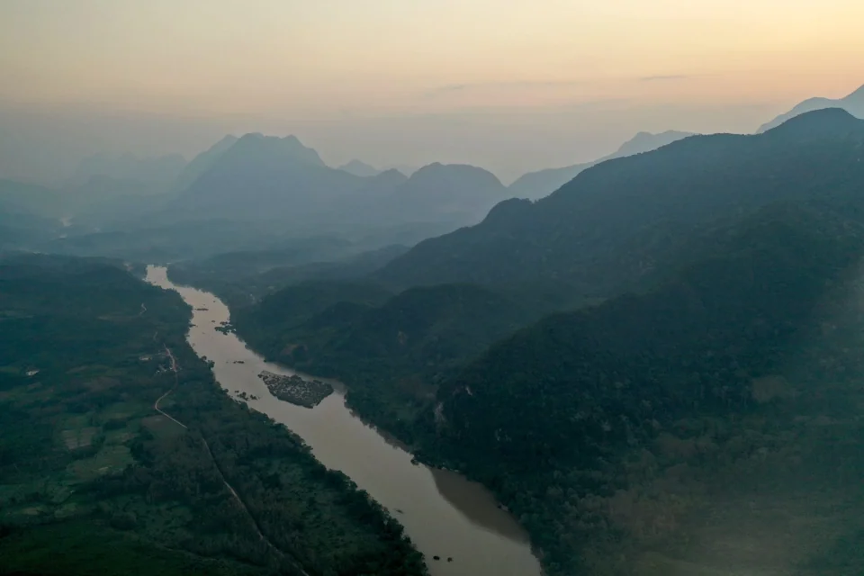 An aerial view of a winding river through mountains