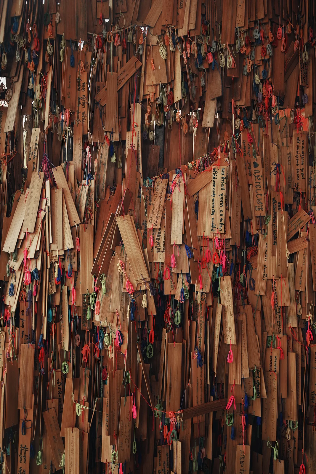 A dense arrangement of colourful hanging objects