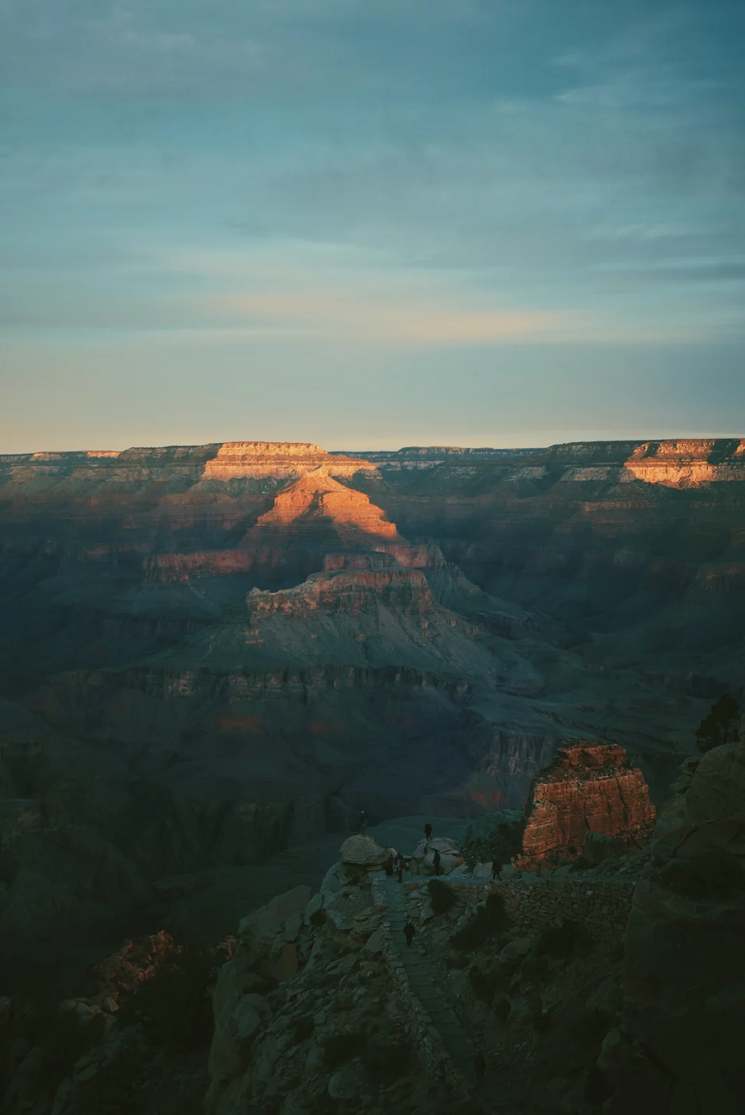 People overlooking sunlit canyon buttes