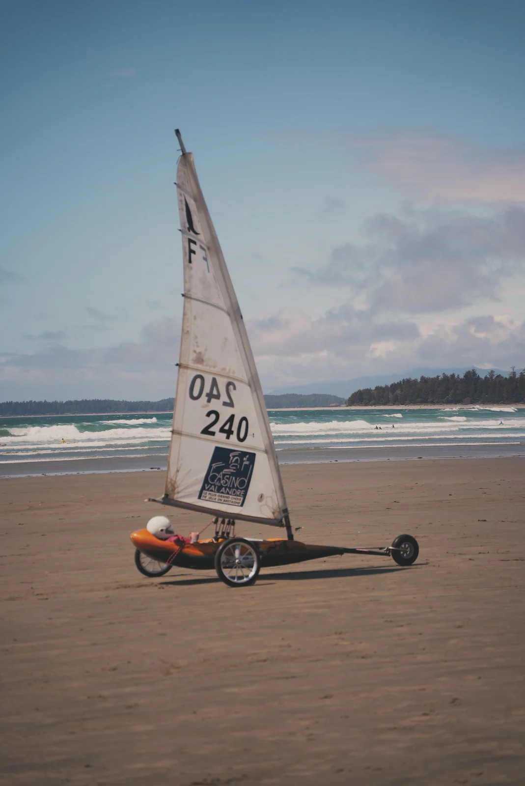 A sand yacht crossing a broad beach