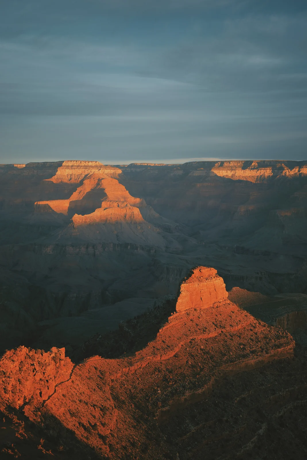 Sunlit orange buttes above a shadowed canyon