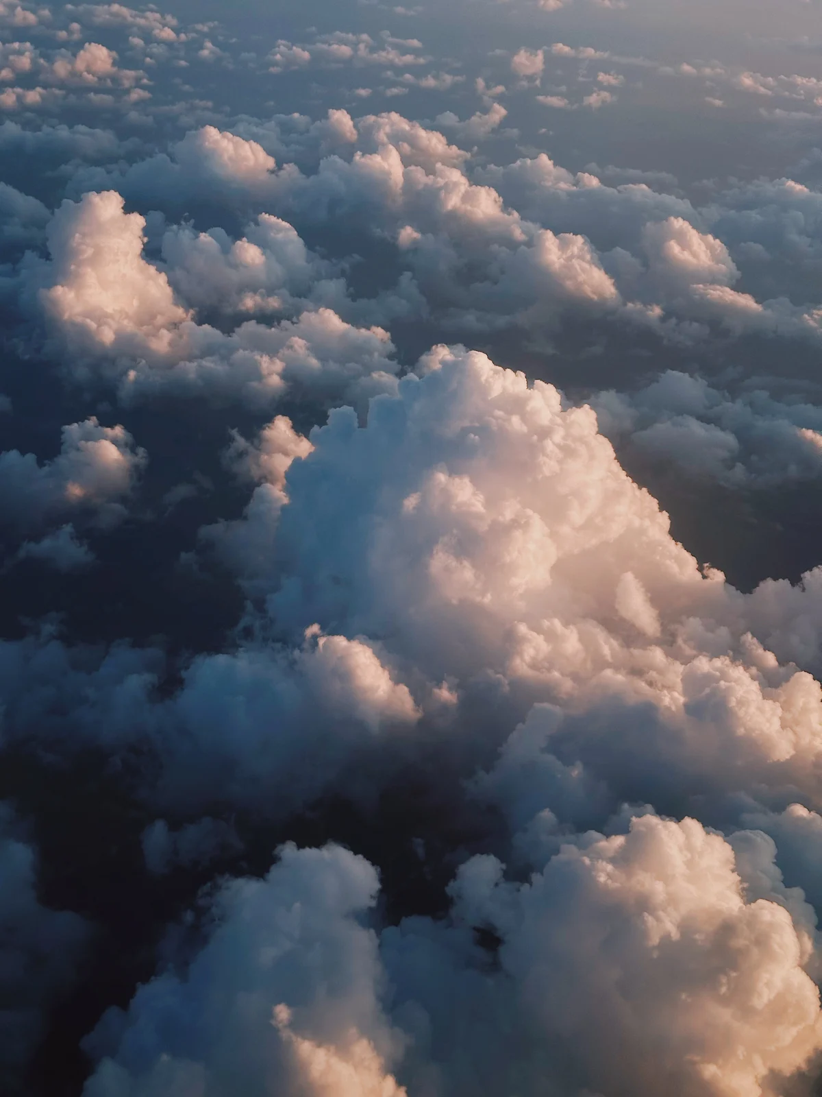 Peach sunlight on clouds seen from above