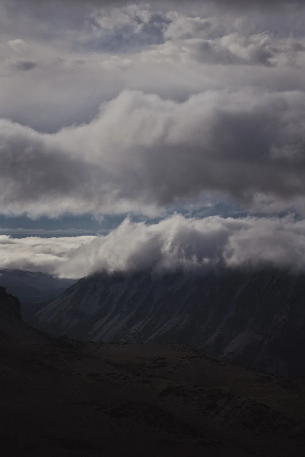 Dramatic cloud layers over a mountain valley