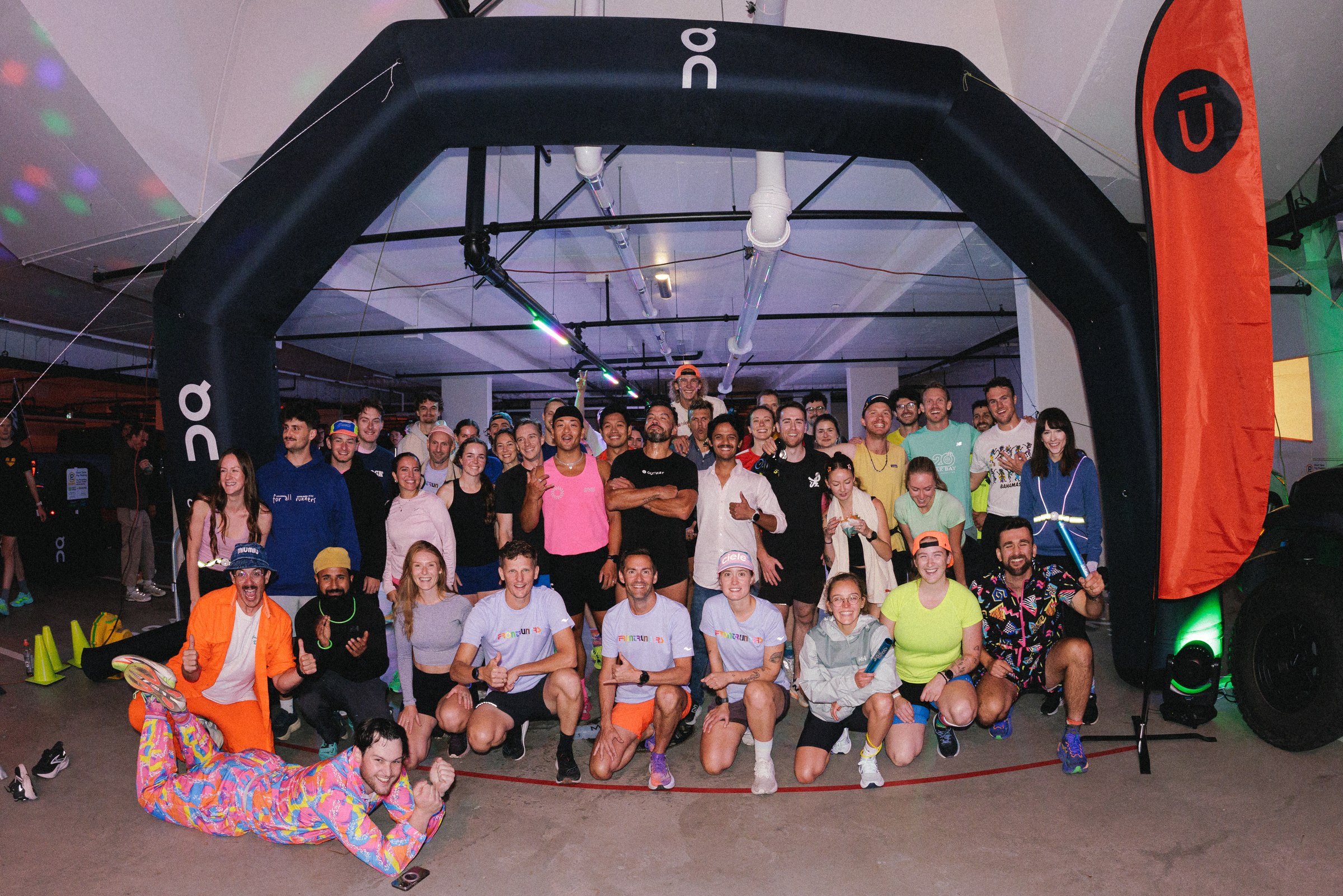 Runners gathered beneath the On arch at Run the Parkade in Victoria